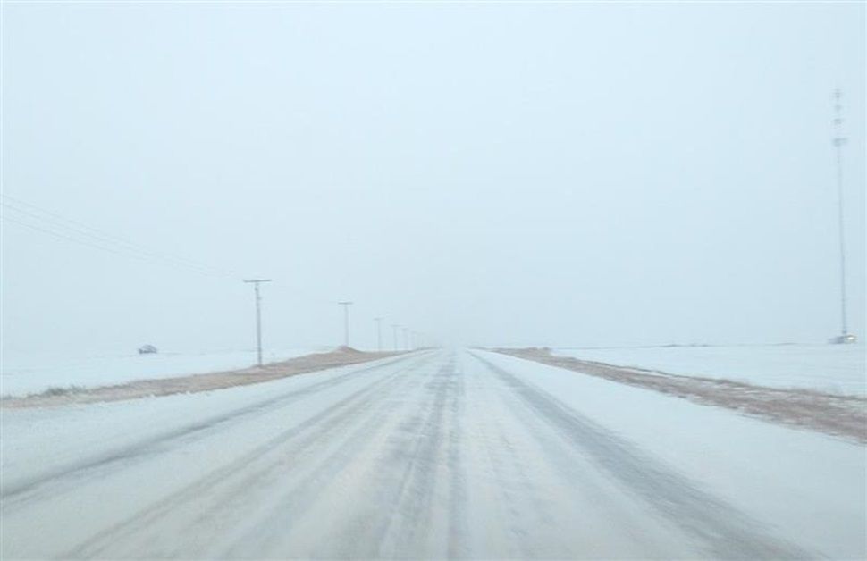 Snow-covered Canadian highway with low visibility
